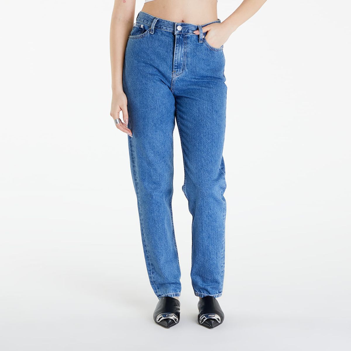 Person wearing blue jeans on a white background