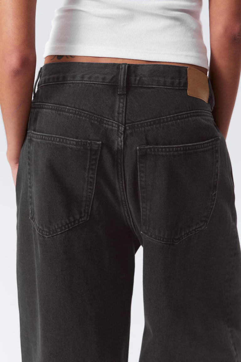 Person wearing black pants with a white background