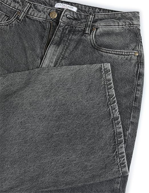 Close-up of gray jeans with a brand label on a white background