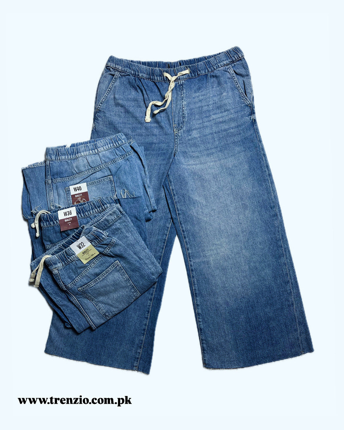 Folded and unfolded blue jeans with tags on a white background, featuring the brand 'Trenzio'.