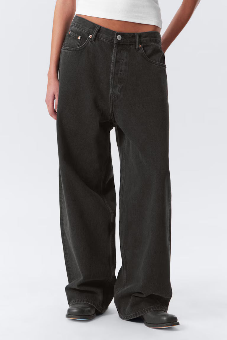Person wearing dark jeans on a white background